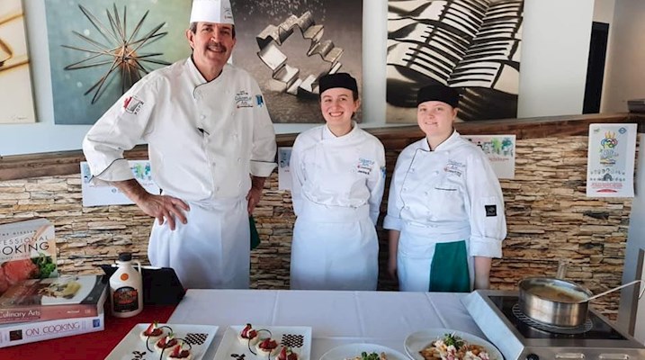 Culinary students standing with chef